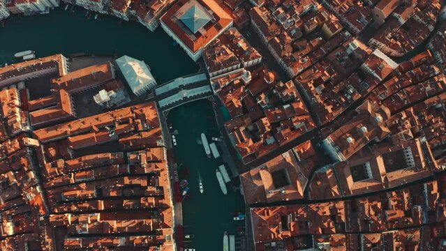 Cinematic reveal drone shot of Ponte di Rialto Bridge Venice Italy at sunrise