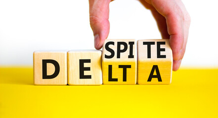 Covid-19 delta variant strain despite symbol. Doctor turns wooden cubes and changes the word delta...