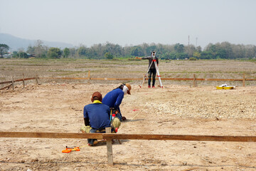 The surveying team for laying piles the piling position has one surveyor engineer looking through a...