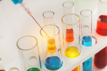 Scientist or researcher conducts experiments and researches scientific liquids in vitro within a research laboratory.