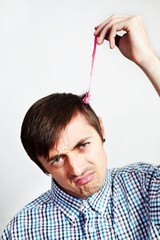 Thats a sticky situation. Portrait of a digruntled man with bubblegum in his hair.