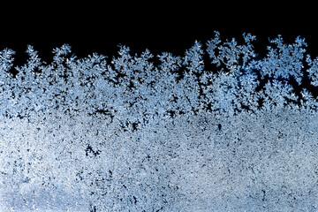 Rime texture on the frozen window in cold winter morning. Background pattern.