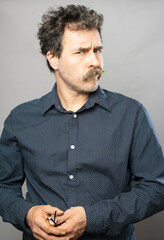 Silly moustache man studio portrait series on grey background
