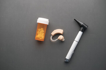 Hearing aid equipment and medical pill container on black 