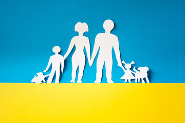 human corridor to get civilians out of the conflict in ukraine. paper cutout of a family on the...