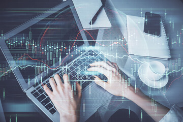 Double exposure of woman hands typing on computer and forex chart hologram drawing. Stock market...