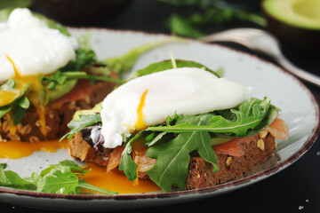 Homemade sandwiches with salmon, avocado and poached eggs