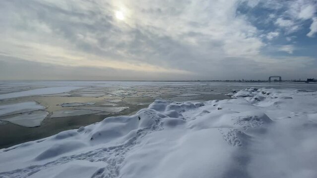 Winter landscape lake superior frozen, Canal park bridge Duluth on the background