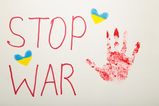 Inscription Stop war with baby handprint on white background, conflict between Ukraine and Russia. No war, stop war, russian aggression. Ukrainian patriot.