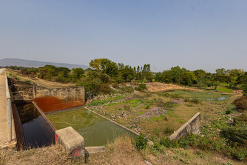 Irrigation canal connected to the spillway of the concrete dam.