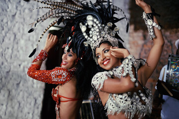 For the joy of samba. Shot of two beautiful samba dancers performing in a carnival. - obrazy, fototapety, plakaty