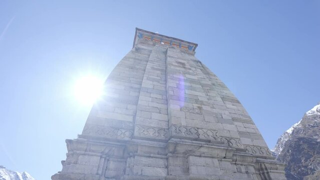 Towering Kedarnath Temple Backlit Bright Sunny Sky In Uttarakhand, India. Low Angle Shot