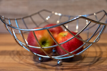 apples in a metal cage