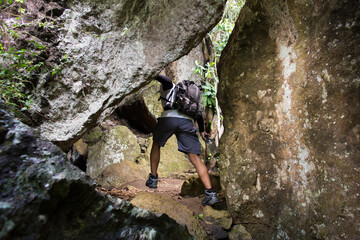 One backpacker man travel alone, with backpack in the mountains
