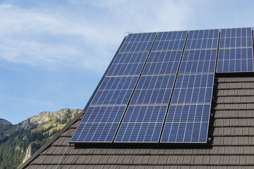 Fototapeta premium Solar panels on the roof of mountain cottage