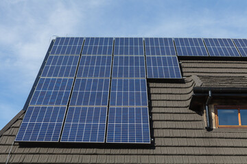 Fototapeta premium Solar panels on the roof of mountain cottage
