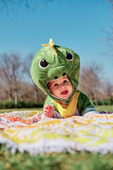 Baby dressed in a dinosaur costume