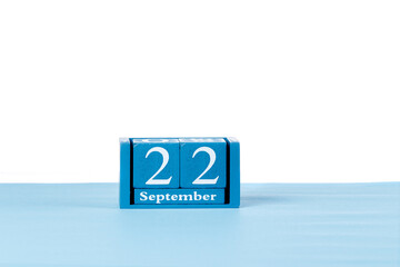 Wooden calendar September 22 on a white background