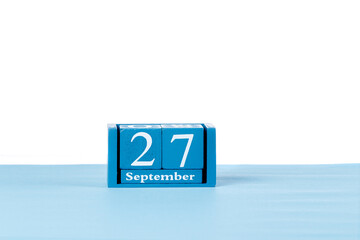Wooden calendar September 27 on a white background