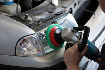 Sanding polishing headlights on a car on a hundred close-up