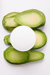 Spa. Photo of cosmetics. White cosmetic container on avocado slices.