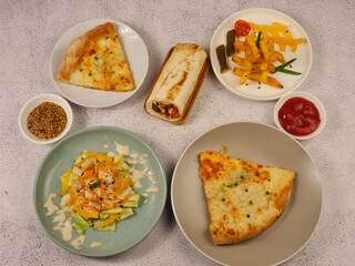 french fries and tomatoes, pizza, vegetable roll and salad