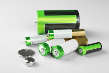 Fototapeta Different types of batteries on light background obraz