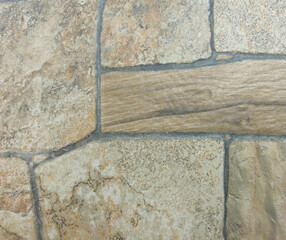 The old stone surface is light brown in color with a stone texture. Light brown vintage background.
