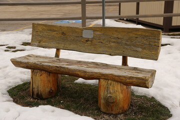 Split log work park bench in the winter