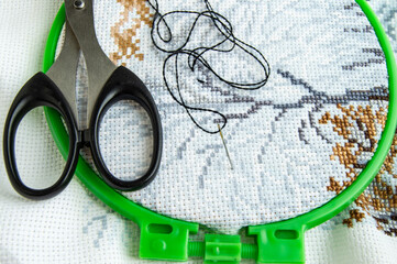 Flat lay canvas with a beautiful pattern of bright sewing threads, scissors and a needle for...