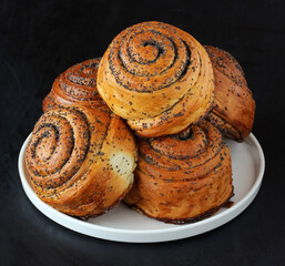 bunch of sweet twisted buns with poppy seeds.