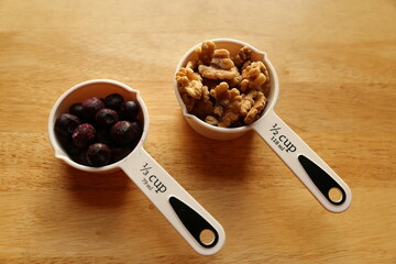 Blueberries and Walnuts in measuring cups.