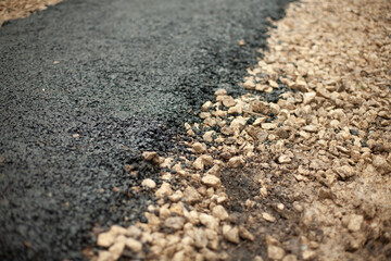 New asphalt. Construction of path in park. Details of road surface.