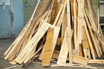 Broken parquet. Waste after repair. Boards from floor. Construction debris on street.