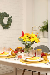 Autumn table setting with floral decor and pumpkins indoors