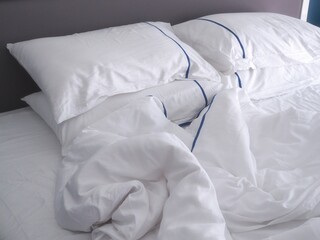 Fototapeta na wymiar Pillows on bed, mattresses and blankets wrinkled.