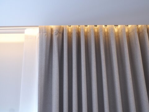 Bedroom window decoration with curtains and ceiling lights.
