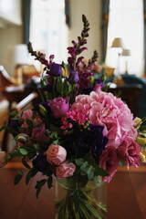 close-up of a beautiful bouquet in a transparent vase with lilac and pink flowers. floral decor