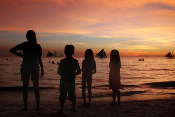 A family enjoy beautiful sunset view in Boracay, Philippines.