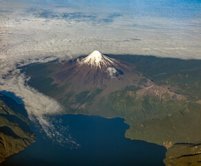 Dramatic aerial view of snow capped volcanos in the Andes mountains of the Patagonia, Chile