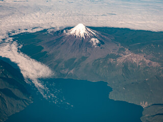 Dramatic aerial view of snow capped volcanos in the Andes mountains of the Patagonia, Chile