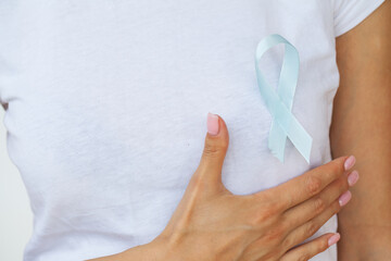 Woman with blue ribbon, prostate cancer awareness