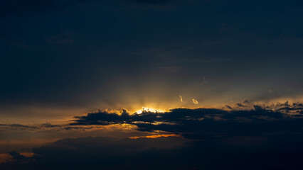 Bright rays at sunset against a dark sky.