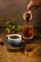 an aromatic coffee freshly grinding to pouring become hot or cold black coffee at wooden rustic tray 