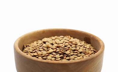 brown lentils in a bowl isolated on white background