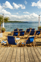 Blue recliner chairs on a tropical beach
