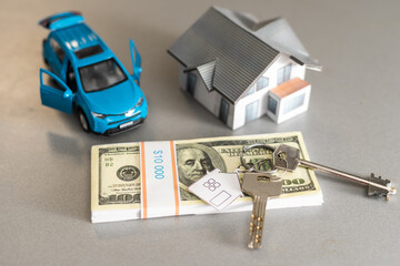 saving money small toy car with house loan concept finance growth and property on gray background...