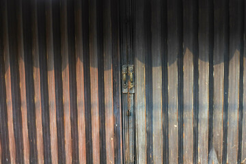 iron rusty folding gate of an old shop