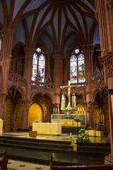 Fototapeta na wymiar Altar in a church with stained glass windows