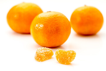 Whole fresh mandarin orange with fruit candy